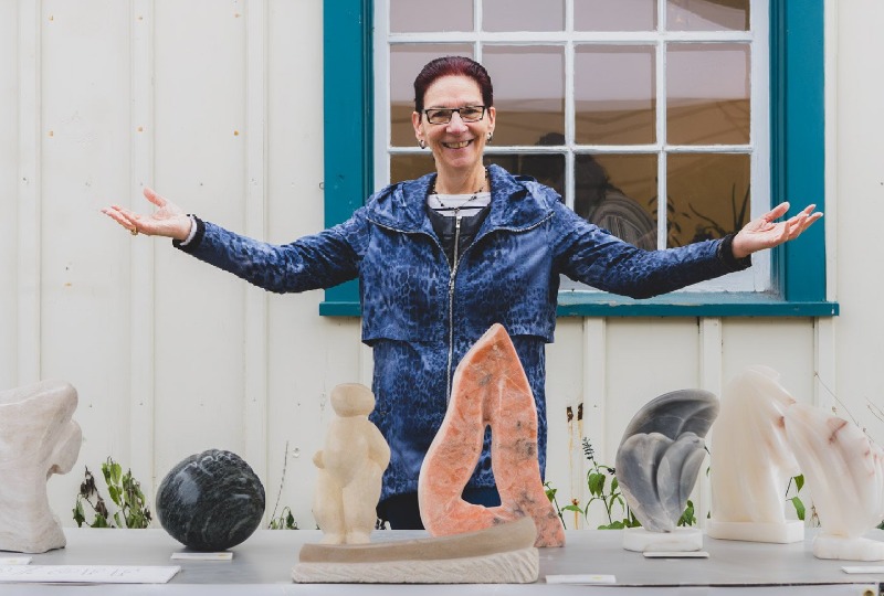 Artist posing with sculptures
